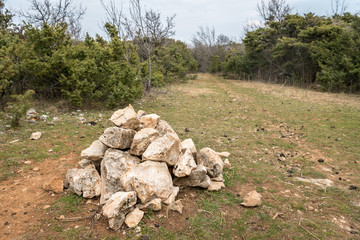Pile of rocks near hiking trail in Croatia