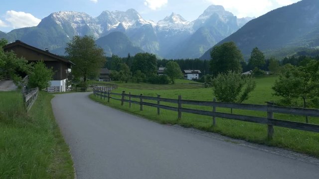 Slow traverse of a rural road in Au near Lofer, Austria, with the Loferer (Lofer) Mountains in the background.