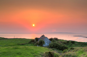 Irish cottage house at sunset
