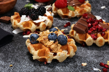 Belgian waffles with pomegranate and raspberries, homemade healthy breakfast with mint