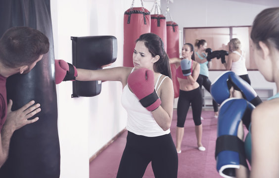 Woman training with punching bag