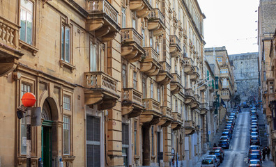 Fototapeta na wymiar Malta, Valletta, building facade with balconies, perspective view