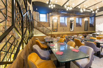 Interior of a modern hotel restaurant with brick wall
