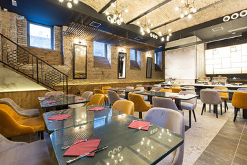 Interior of a modern hotel restaurant with brick wall