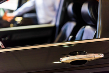 New car at dealer showroom blurred background