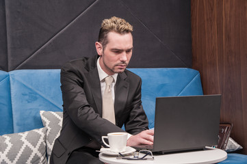 businessman / 
businessman sitting in the office behind the desk and checked sales analysis...