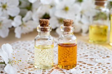 Bottles of essential oil with white blossoms