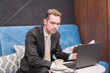 businessman / 
businessman sitting in the office behind the desk and checked sales analysis...