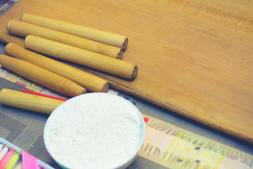 many culinary rolls for dough with grated cheese on the table