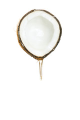 Half of a coconut with a flowing transparent liquid on a white background