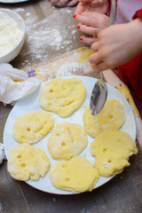 Children and chefs make dough on the table with their hands
