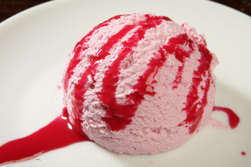 Strawberry saucy ice cream on plate