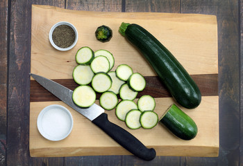 Fresh, organic zucchini.  Whole and sliced top view.