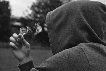 Mysterious faceless person smoking wearing a hood