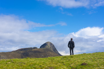 Man walking with mountains in the background, Aiako Harriak natural park