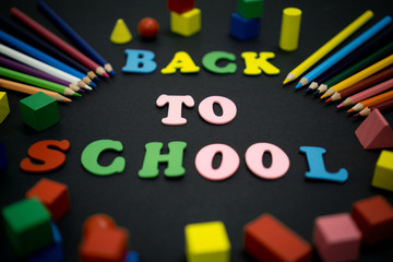 Selective focus of colorful Back to School text title on black background