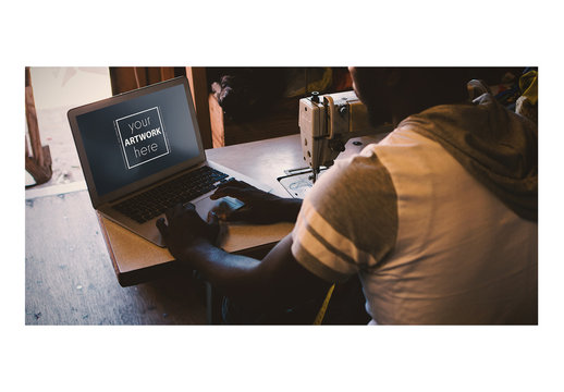 Laptop User Seated at Sewing Machine Mockup