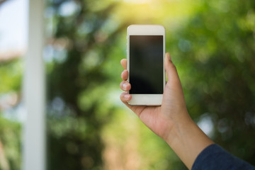 Woman using cellphone in public park.