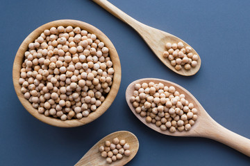 dry raw chickpeas in wooden bowl and spoons