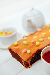 Sweet birthday dessert. Chocolate cake with orange frosting