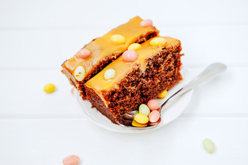 Sweet birthday dessert. Chocolate cake with orange frosting