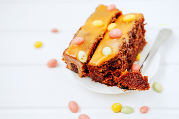 Sweet birthday dessert. Chocolate cake with orange frosting