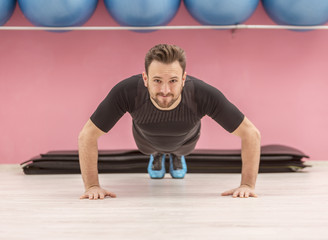 Fototapeta premium Portrait of a Young Man Doing Pushups