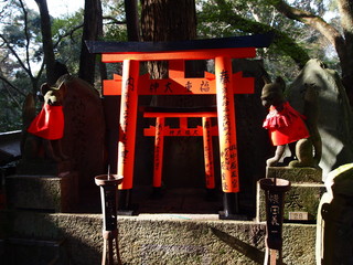 Foxes and Gates of Fushimi Inari Shrine, Kyoto, Japan