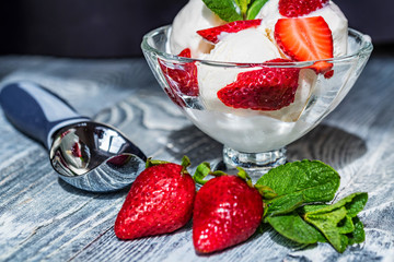 Strawberry ice cream in bowl and strawberries