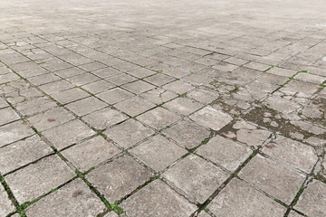 Full frame background of old and weathered cement paving slabs outdoors