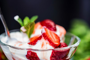 Strawberry ice cream with mint in bowl