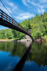 Fototapeta na wymiar Swinging bridge over the mouth of the Black River in Michigan n