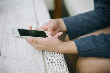 Closeup of woman hands using smartphone