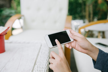 Closeup of woman hands using smartphone