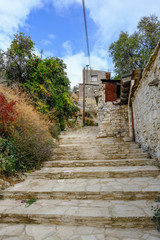 Fototapeta na wymiar Steep steps up toward s the top of the village in Arsos