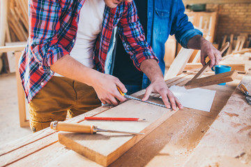 Close up of Carpenters Measuring A Wooden Plank