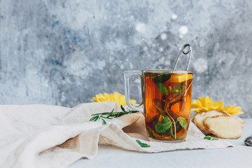 Black Hot tea with lemon and ginger on linen napkin