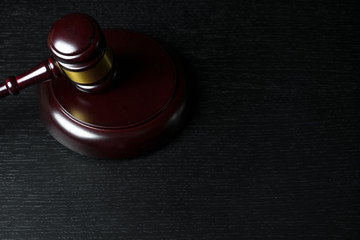 Judge gavel on black wooden background