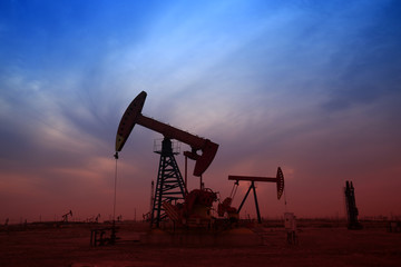 Pumping unit in the work, under the background of the setting sun