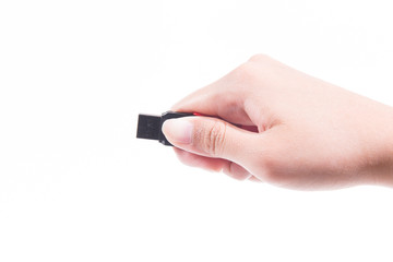 Woman hand holding up a flash drive isolated on a white background