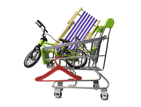 Isolated travel stuff, purchases for journey: bicycle, hanger and chaise-longue in the shopping cart. Tourist concept.