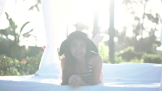 woman on the lounger by the pool