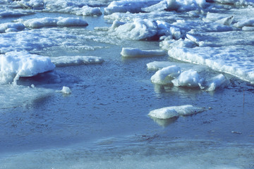 large pieces of ice are white.ice drift on the river. large ice floes floating on the water. spring...
