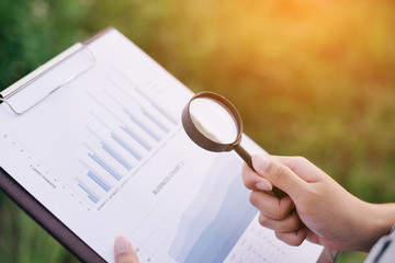 Young business woman hand write business chart. Graphs Concept