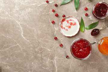 Obraz na płótnie Canvas Jars with different sweet jam on textured background
