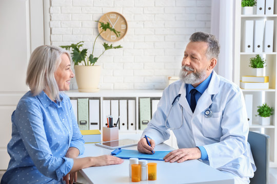 Mature doctor consulting patient in clinic