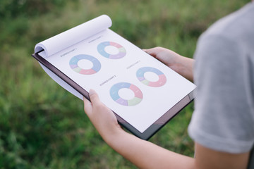 Young business woman hand write business chart. Graphs Concept