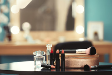 Decorative cosmetics and tools on dressing table in makeup room, closeup