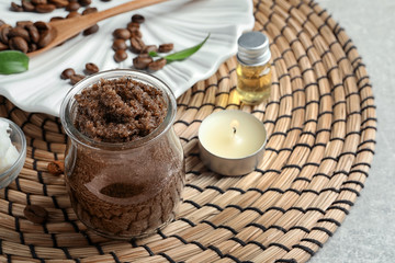 Glass jar of coffee scrub on wicker mat