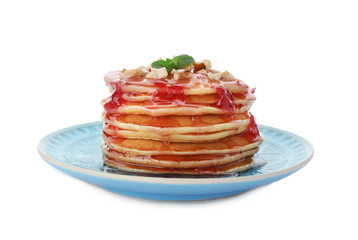 Plate with delicious pancakes on white background